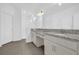Bright bathroom featuring double sinks, granite counters, and modern finishes at 4472 Lions Gate Ave, Clermont, FL 34711