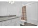 Bright bathroom featuring granite countertops, white cabinets, and a shower-tub combo at 4472 Lions Gate Ave, Clermont, FL 34711