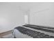 Comfortable bedroom showcasing a bed with a patterned comforter and white closet doors at 4472 Lions Gate Ave, Clermont, FL 34711