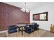 Dining room with stylish wallpaper, contemporary chandelier, and a wooden dining table at 4472 Lions Gate Ave, Clermont, FL 34711