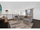 Modern living room featuring a gray sectional sofa, stylish rug, and minimalist decor at 4472 Lions Gate Ave, Clermont, FL 34711