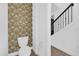 Half bathroom with floral wallpaper and hardwood floors at 4472 Lions Gate Ave, Clermont, FL 34711