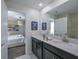 Bright bathroom with double sinks, sleek cabinets, and modern fixtures, conveniently located near the bedroom for ease of use at 4532 Target Blvd, Kissimmee, FL 34746
