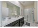 This bathroom features double sinks, granite counters, and a glass-enclosed shower at 4532 Target Blvd, Kissimmee, FL 34746