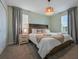 Cozy bedroom with stylish light fixture, bedside table, and decorative throw pillows at 4532 Target Blvd, Kissimmee, FL 34746