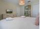 Bright bedroom with a plush queen-size bed, soft lighting, and neutral tones, perfect for a restful night's sleep at 4532 Target Blvd, Kissimmee, FL 34746