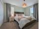 Serene bedroom with a comfortable queen-size bed, soft lighting, and neutral tones, offering a relaxing retreat at 4532 Target Blvd, Kissimmee, FL 34746