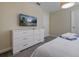 Bright bedroom featuring a modern dresser and a wall-mounted TV for relaxed viewing at 4532 Target Blvd, Kissimmee, FL 34746