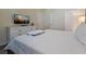 Bedroom with a dresser, television, and a comfortable queen-sized bed with fresh linens at 4532 Target Blvd, Kissimmee, FL 34746