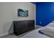 Bedroom with a modern TV above a dresser and blue accent wall at 4532 Target Blvd, Kissimmee, FL 34746