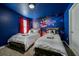 Themed bedroom with twin beds, a cosmic mural, and vibrant colors, creating a fun and imaginative space for  at 4532 Target Blvd, Kissimmee, FL 34746