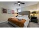 Comfortable bedroom featuring a king bed with a tufted headboard and matching nightstands at 4532 Target Blvd, Kissimmee, FL 34746