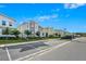 Street view of modern townhomes featuring landscaping, sidewalks and parking at 4532 Target Blvd, Kissimmee, FL 34746