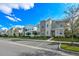Exterior view of modern townhomes featuring landscaping, sidewalks and parking at 4532 Target Blvd, Kissimmee, FL 34746