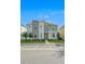 Inviting two-story townhome featuring stone accents and a well-maintained front yard landscape at 4532 Target Blvd, Kissimmee, FL 34746
