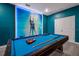 Bright blue game room showcasing a pool table with vibrant wall decor and modern lighting at 4532 Target Blvd, Kissimmee, FL 34746