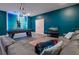 Recreation room with a leather sofa, TV, and a pool table with unique Tron-themed wall decor at 4532 Target Blvd, Kissimmee, FL 34746