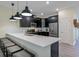 Eat-in kitchen features long countertop island with sink, stainless steel appliances, and gray wood-look flooring at 4532 Target Blvd, Kissimmee, FL 34746