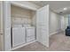 Laundry area featuring a washer and dryer behind a closet door at 4532 Target Blvd, Kissimmee, FL 34746