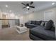 Cozy living room features plush seating and a ceiling fan, creating a comfortable and inviting space for relaxation at 4532 Target Blvd, Kissimmee, FL 34746