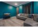 Comfortable living room with a grey sofa and a TV, featuring Tron-themed decor and dark curtains at 4532 Target Blvd, Kissimmee, FL 34746