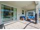 Covered patio features large sliding glass doors and wicker seating with blue cushions at 4532 Target Blvd, Kissimmee, FL 34746