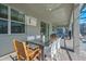 Covered patio with dining table and seating overlooks screened-in pool at 4532 Target Blvd, Kissimmee, FL 34746