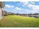Expansive backyard featuring lush green grass and tranquil pond views, perfect for outdoor relaxation at 4770 Cains Wren Trl, Sanford, FL 32771