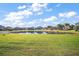 Spacious backyard with green grass and a serene pond, offering a peaceful outdoor retreat at 4770 Cains Wren Trl, Sanford, FL 32771