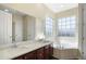 Bright bathroom with a double vanity, large mirror, soaking tub, and natural light at 4770 Cains Wren Trl, Sanford, FL 32771