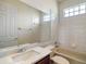 Well-lit bathroom with a tub-shower combination, modern fixtures, and a large mirror at 4770 Cains Wren Trl, Sanford, FL 32771