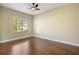 Bedroom featuring hardwood floors, neutral paint, large window, and ceiling fan at 4770 Cains Wren Trl, Sanford, FL 32771