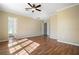 Spacious bedroom featuring a ceiling fan, neutral paint, and gleaming wood floors at 4770 Cains Wren Trl, Sanford, FL 32771