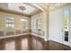 The dining room has a large window and a light-colored wall that contrasts with the dark hardwood flooring at 4770 Cains Wren Trl, Sanford, FL 32771