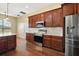 Modern kitchen featuring stainless steel appliances, dark cabinets, white countertops and hardwood flooring at 4770 Cains Wren Trl, Sanford, FL 32771