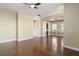 The living room connects to the kitchen and dining room and has light walls with dark hardwood flooring at 4770 Cains Wren Trl, Sanford, FL 32771