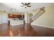 Open-concept living room flows into kitchen with wood floors and staircase at 4770 Cains Wren Trl, Sanford, FL 32771