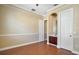 Empty room featuring chair rail molding, neutral walls, hardwood floors, and an adjacent bathroom at 4770 Cains Wren Trl, Sanford, FL 32771