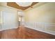 Room with custom ceiling, chair rail molding, hardwood floors, and a double door closet at 4770 Cains Wren Trl, Sanford, FL 32771