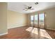 Bright room with laminate wood floors, neutral walls, and three large windows at 4770 Cains Wren Trl, Sanford, FL 32771