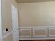 Empty room featuring chair rail molding, neutral walls, and hardwood floors at 4770 Cains Wren Trl, Sanford, FL 32771