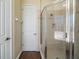 Tiled shower with glass doors adjacent to a door that leads to the bathroom at 4770 Cains Wren Trl, Sanford, FL 32771