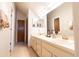 Bathroom features dual sinks, vanity space, ample lighting, and neutral finishes at 5016 Fawn Ridge Rd, Orlando, FL 32819