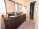 Bathroom with granite vanity and dual sinks, next to a stall shower with glass door at 5016 Fawn Ridge Rd, Orlando, FL 32819