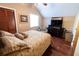 Bedroom with wood floors, vaulted ceiling, and a large window providing ample natural light at 5016 Fawn Ridge Rd, Orlando, FL 32819