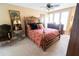 Bedroom with a luxurious bed, ceiling fan, and natural light streaming through the window at 5016 Fawn Ridge Rd, Orlando, FL 32819