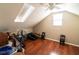 Attic room with hardwood floors and natural light, perfect for extra storage or hobby space at 5016 Fawn Ridge Rd, Orlando, FL 32819