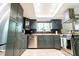 Modern kitchen with stainless appliances, granite countertops, and a window overlooking the backyard at 5016 Fawn Ridge Rd, Orlando, FL 32819