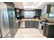 Updated kitchen featuring stainless steel appliances, granite countertops, and dark cabinetry at 5016 Fawn Ridge Rd, Orlando, FL 32819