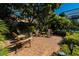 Inviting brick patio with comfortable wooden furniture, surrounded by tropical landscaping and foliage at 5016 Fawn Ridge Rd, Orlando, FL 32819